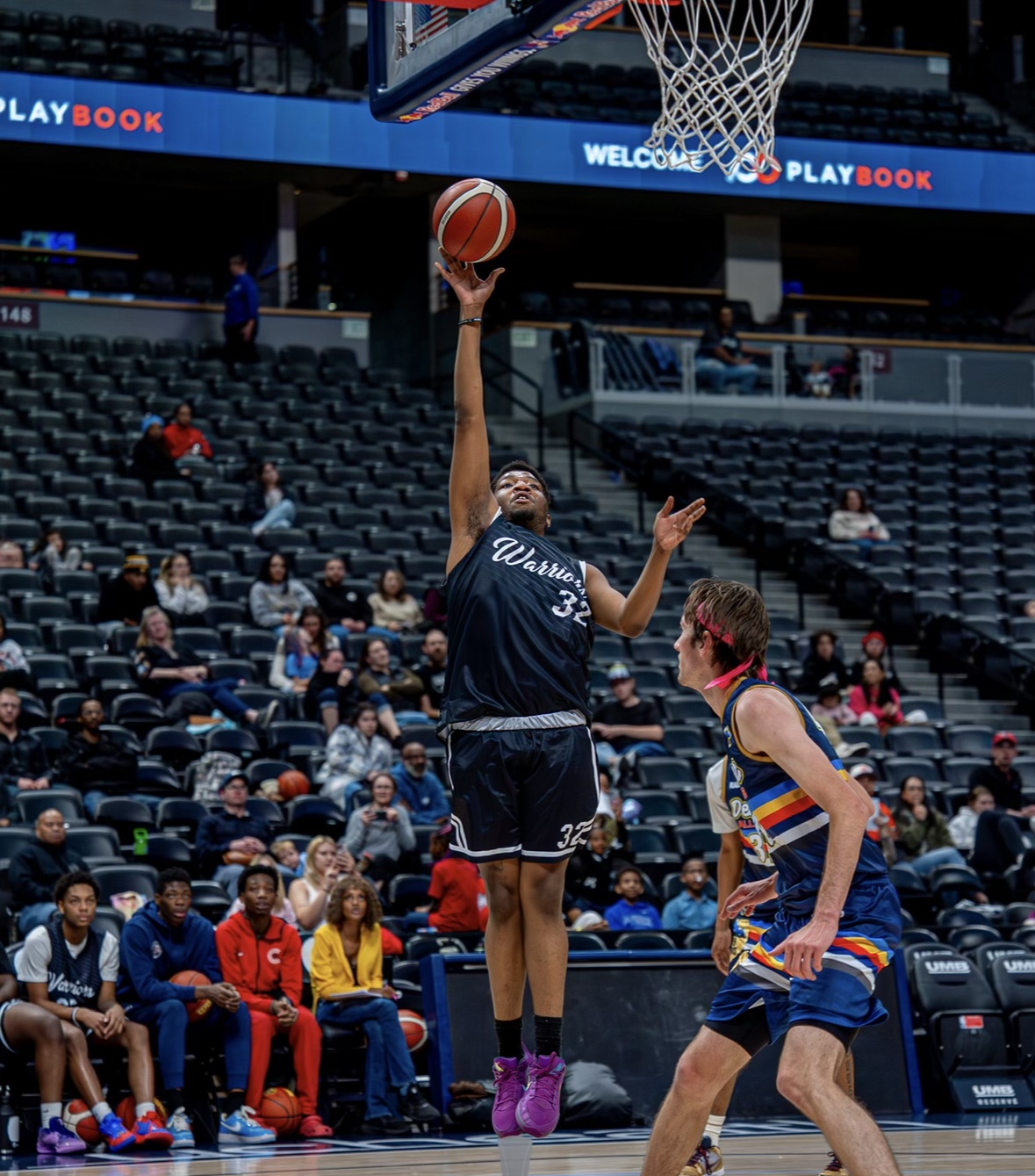 Colorado Warriors player finishing a shot at the basket against the Denver Allstars