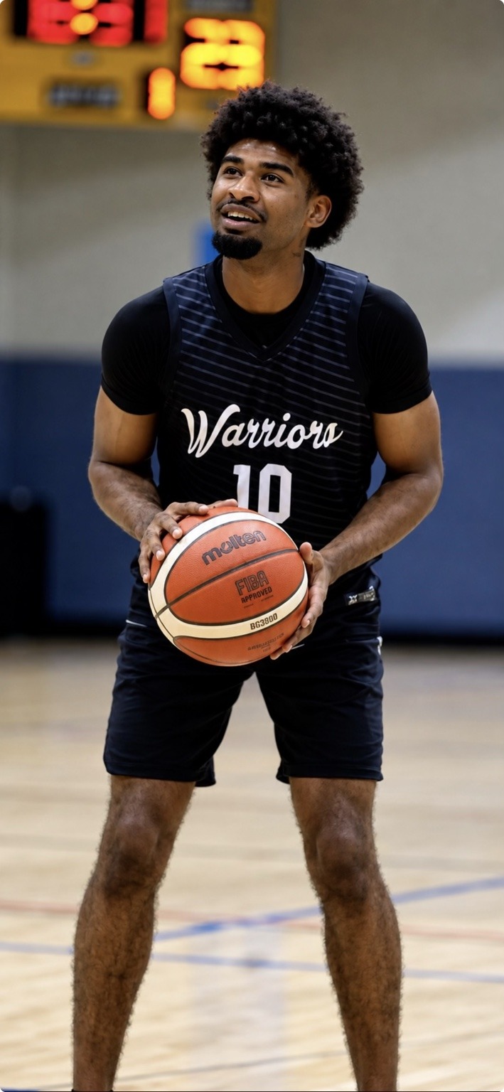 Terrell Smith holding a basketball in his Colorado Warriors uniform